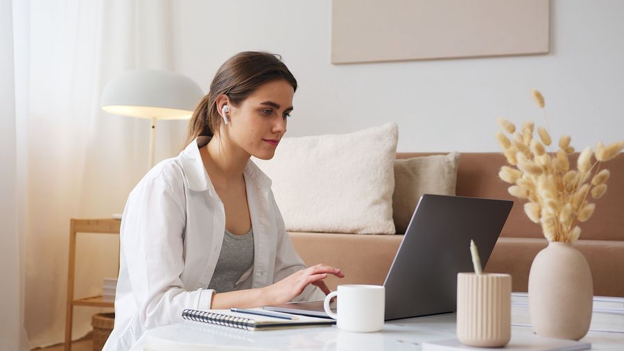 Woman comfortably using a laptop at home
